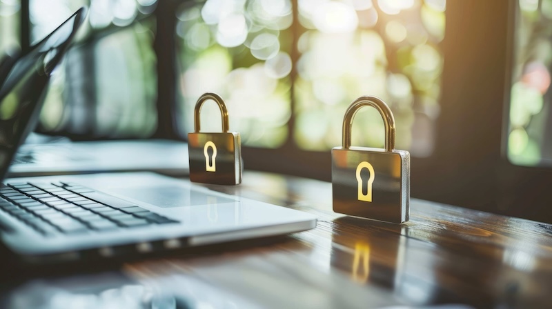 Laptop on a desk with two locks in front