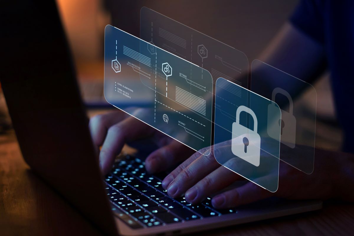 Secure Computing A person working on a laptop with a screen that shows a lock and secure encryption.